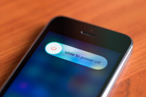 A photo showing an iPhone with the “slide to power off” message showing on the screen.