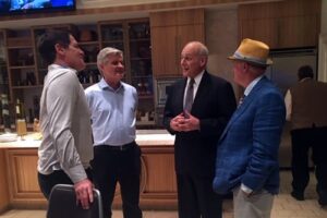 An image showing Mark Skousen, Mark Cuban and Steve Case discussing geopolitics with John Kelly at the SALT Conference.