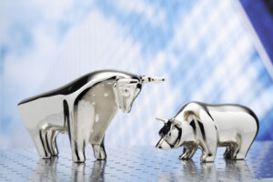 A conceptual image showing figurines of a bull and a bear.