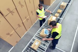 An overhead photo showing two warehouse employees working on order fulfillment.