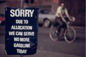 A photo showing a gas station sign during the 1970s energy crisis reading “Sorry, due to allocation we can serve no more gasoline today.”