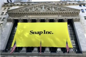 A photo showing a large yellow Snap Inc. sign on the New York Stock Exchange building marking the day of the startup’s IPO.