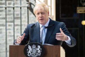 A photo of Prime Minister Boris Johnson delivering a speech outside of 10 Downing Street.