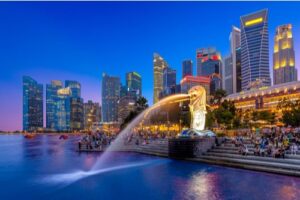 A nighttime view of Marina Bay in Singapore with the skyline in the background.