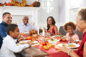 A photo of a family gathered around a table for Thanksgiving dinner