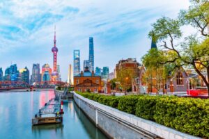 A photo showing the skyline and waterfront of Shanghai, China, at dusk.