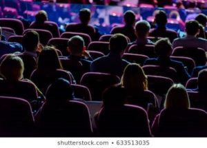 An audience listening to a speaker