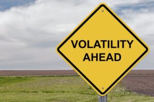 A photo showing a road warning sign stating “Volatility Ahead.”