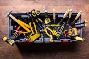 An overhead photo showing a well-stocked toolbox including many different tools.