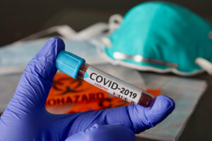 A photo showing a blood vial labeled COVID-19 positive.