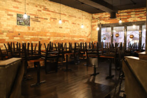 A photo showing an empty restaurant with chairs stacked on the tops of tables during the coronavirus crisis.