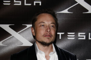 A photo of Elon Musk at a Tesla event.