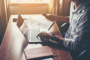 An investor researches a company on his laptop