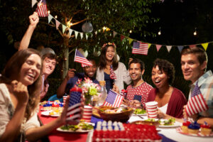 A photo of friends enjoying a backyard barbecue to celebrate the Fourth of July.