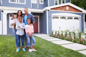 A Black family stands in front of their home