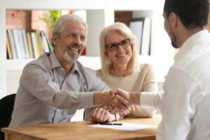 A senior couple speaks with their broker