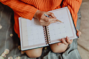 A woman writes in her daily planner