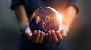 A person holds the globe in their hands