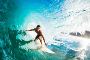 A surfer rides an ocean wave