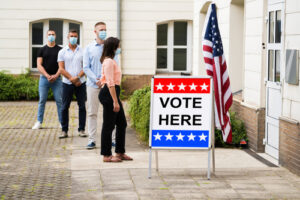 Voters wait outside of a polling station