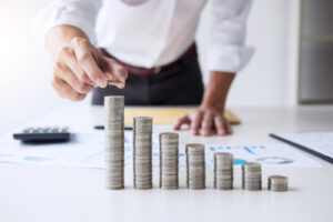 A businessman stacks coins on his desk