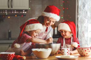 A mother and her children bake cookies for Christmas