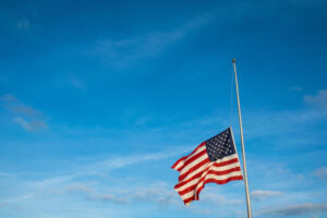 An American flag flies at half-mast