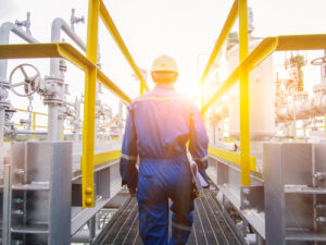 A worker enters an oil refinery