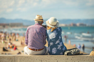 A retired couple enjoys a vacation at the beach