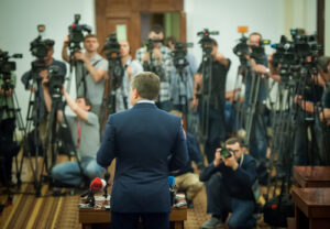 A man speaks to reporters at a press conference