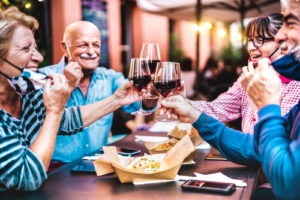 A group of people dining at a restaurant and enjoying wine.