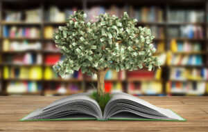 A money tree grows out of a book