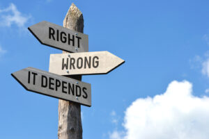 An image of a wooden signpost against a blue sky reading “Right, Wrong, It Depends.”