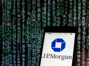 An image of a phone showing the JPMorgan Chase logo in front of a background of code.