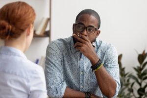 A photo showing a businessman speaking to a female employee with a skeptic look on his face.