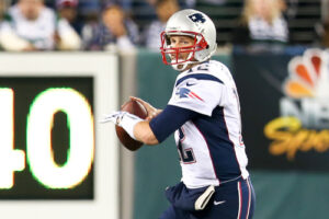 A photo showing Tom Brady throwing a pass as quarterback for the New England Patriots.