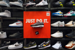 A photo showing a large display of Nike shoes in a store.