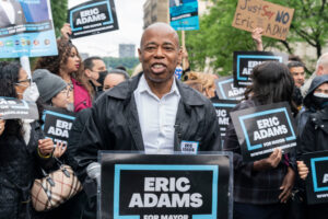 A photo of Eric Adams surrounded by supporters at a rally in New York City.