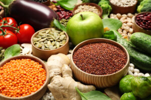 A photo showing a selection of healthy foods, including vegetables, fruits and seeds.