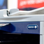 A close-up photo of the blue and white Xerox logo on the side of the company’s copy machine.