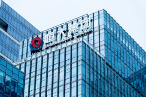 A photo of the China Evergrande Group logo on the side of a tall office building