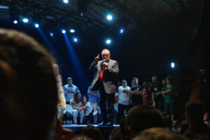 A photo of former president of Brazil Luiz Inácio Lula da Silva on stage speaking to a crowd at Circo Voador in Rio de Janeiro