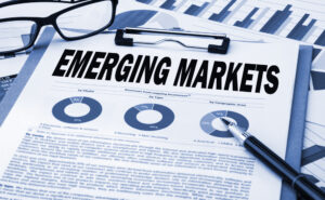 An illustrated concept of an emerging markets analysis sheet on a clipboard.