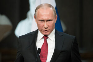 Vladimir Putin speaking at a press conference at the Palace of Versailles.