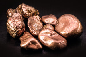 Nuggets of copper on a black tablecloth.