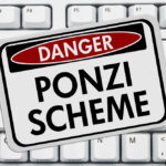 A danger sign warning of a Ponzi scheme over a keyboard.