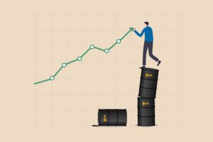 A man standing on oil barrels as energy stocks rise.