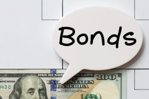 A hundred-dollar bill with the word “bonds” in a bubble.