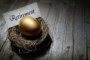 A nest holding a golden egg with the word “retirement” on a piece of paper.