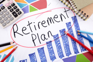 The words “Retirement Planning” circled on a piece of paper, surrounded by other metrics and tools.